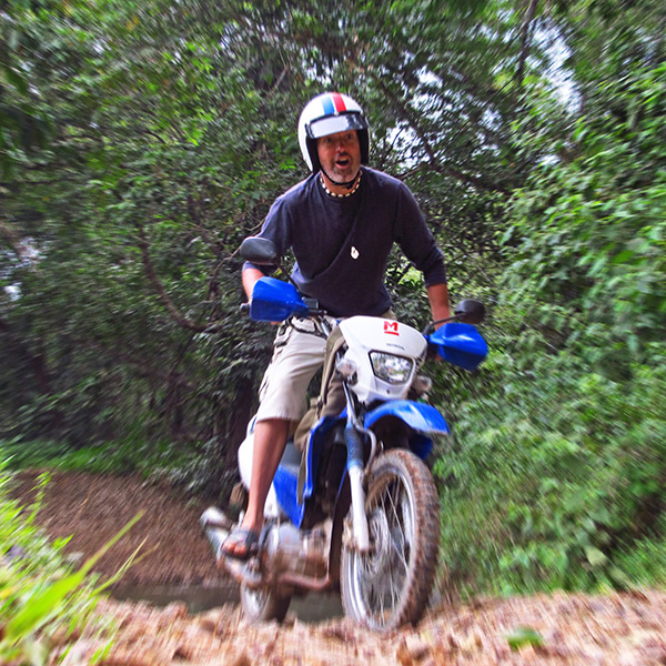 Simon Jones riding a motorbike in the Philippines